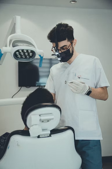 a patient on a dental chair while the dentist do his job