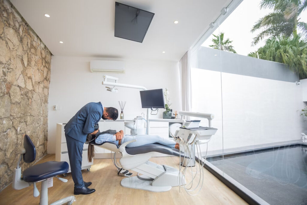 a male dentist performing a dental procedure